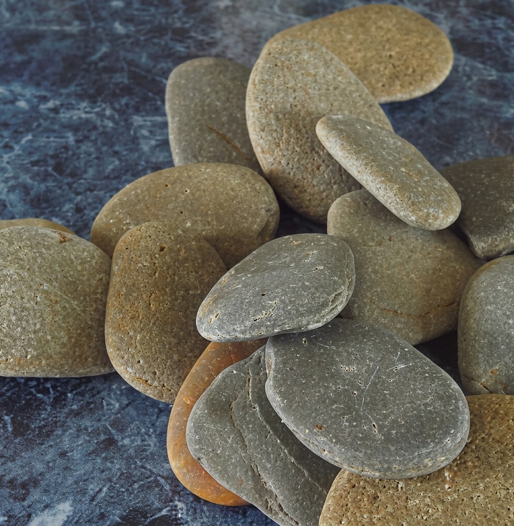 Smooth yellowish river rocks waiting to be painted
